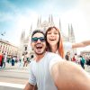 Happy couple taking selfie in front of Duomo cathedral in Mi (1)